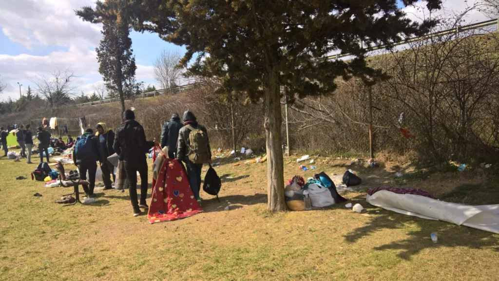 Group of migrants organizing their belongings for the journey