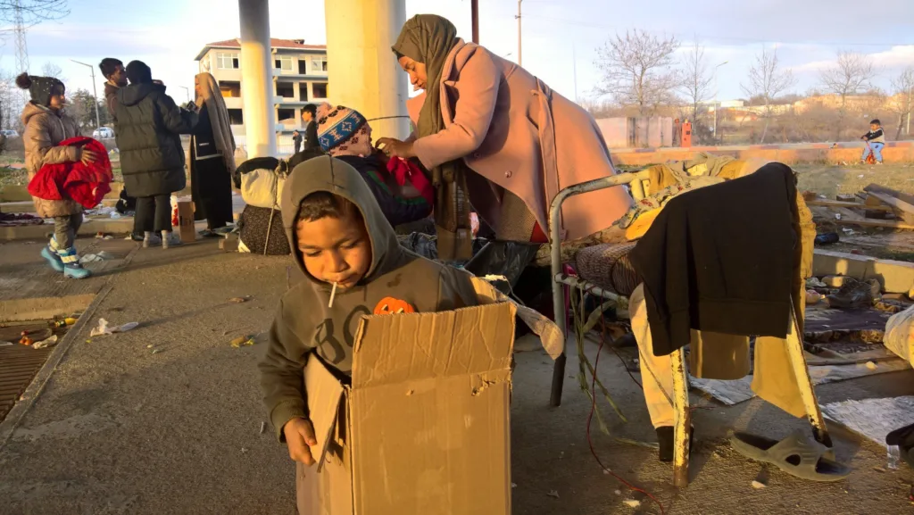 Refugee child finding joy in a cardboard box